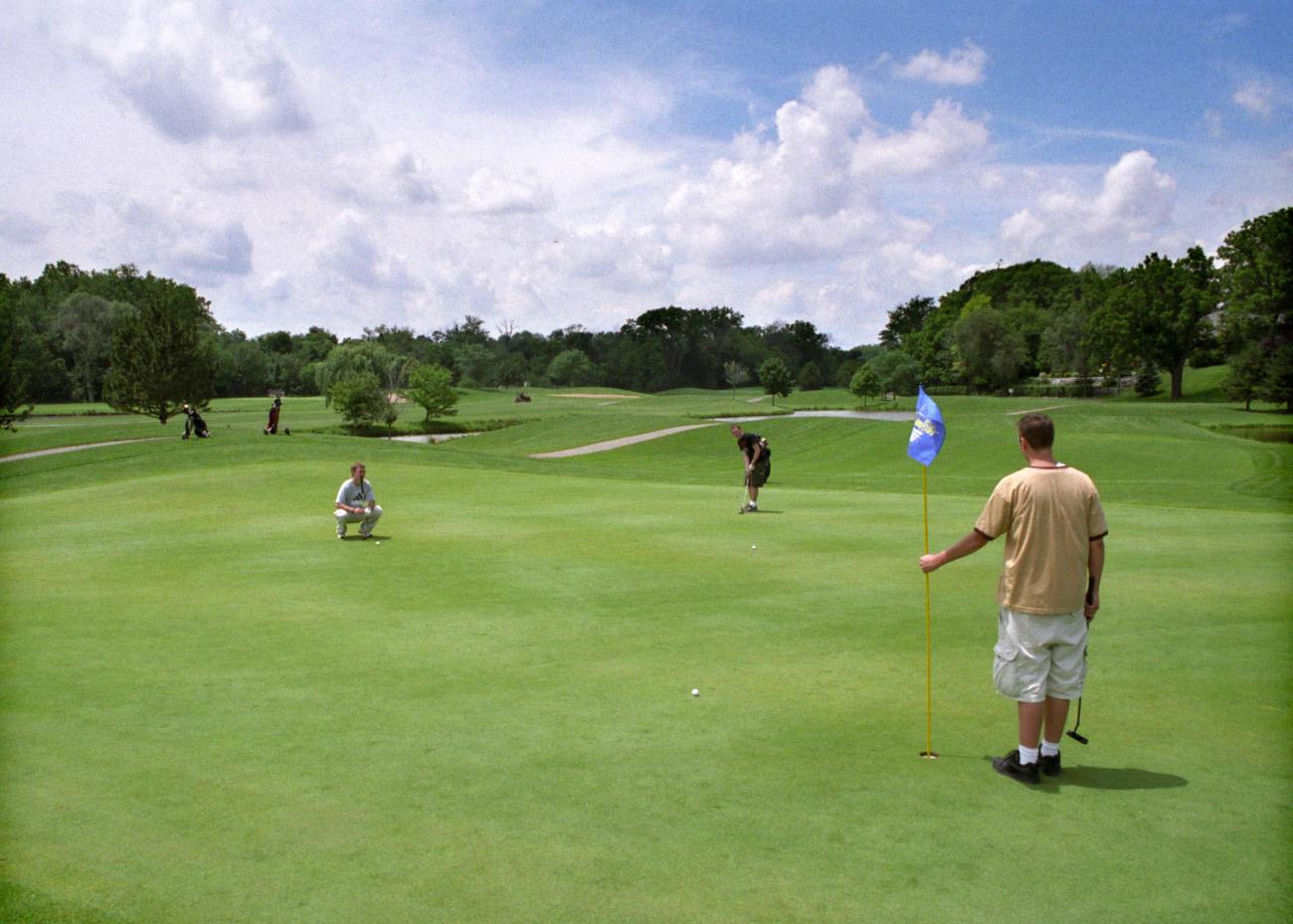 Golfers putting at Dearborn Hills Golf Course