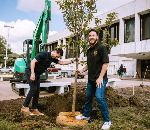 Mayor Hammoud and Chief Public Health Officer Ali Abazeed plant a tree together outside the Henry Ford Centennial Library