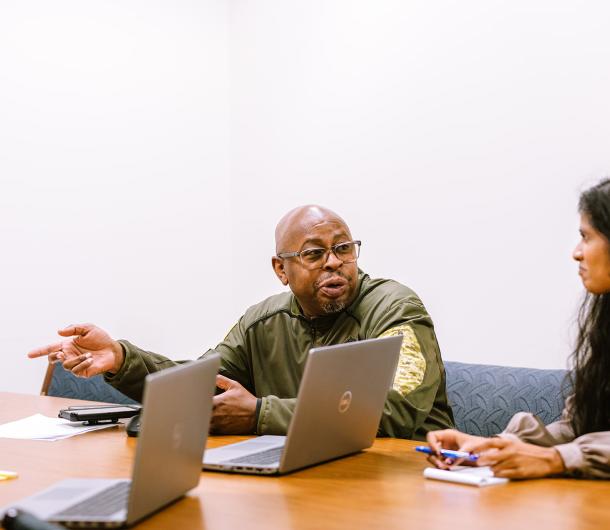 Staff members sitting together at a table. 