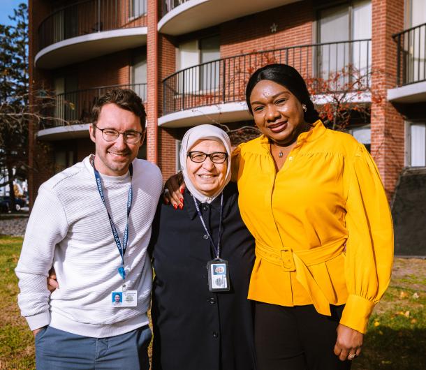 Three members of the Dearborn Housing Division staff pose together outside O'Reilly Jr Manor